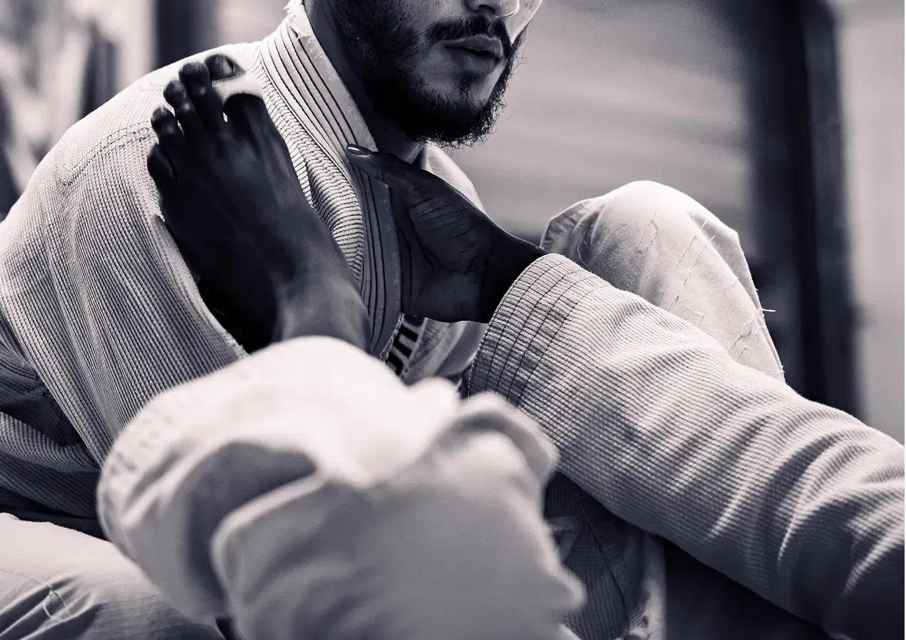 Pratiquant en kimono blanc en garde, en noir et blanc